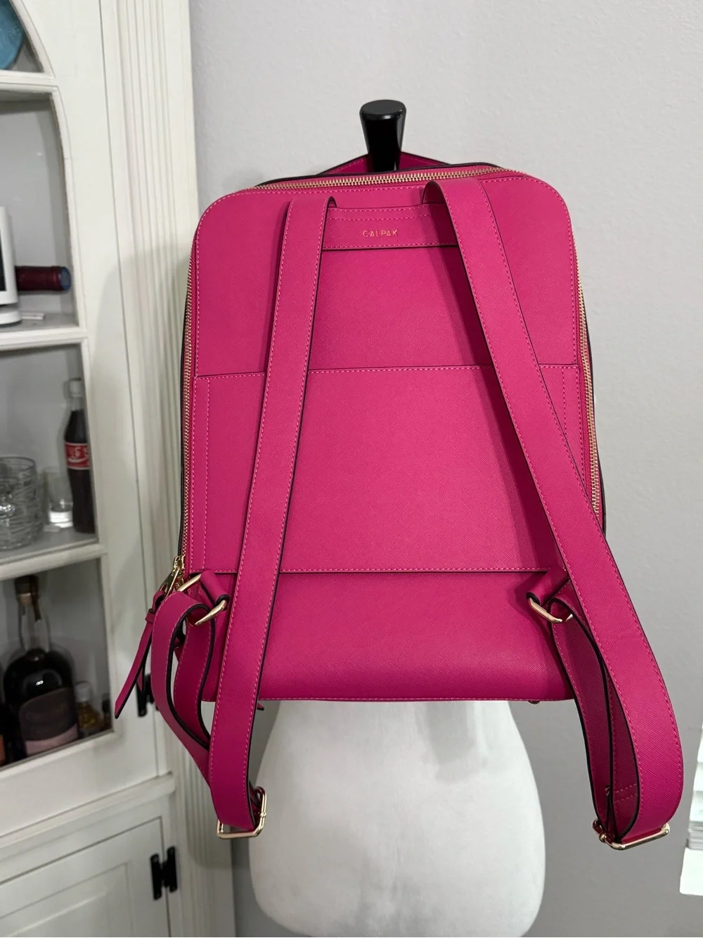 CALPAK Kaya Laptop Backpack in the vibrant Dragonfruit hot pink